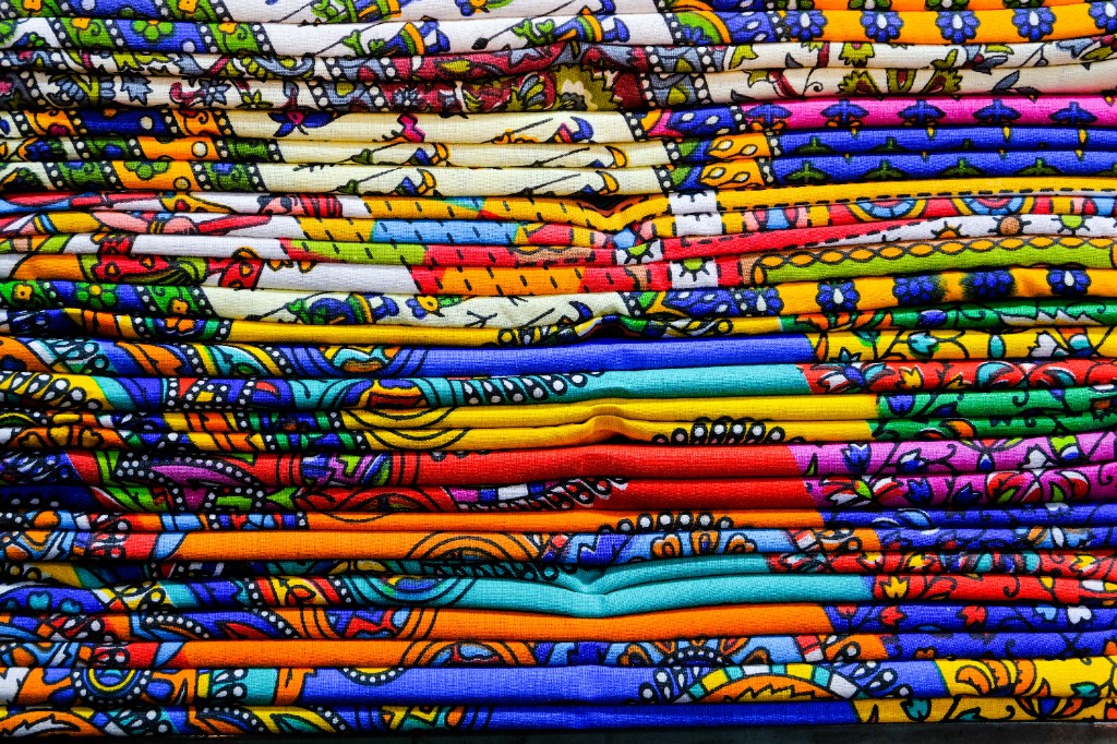 Stacks of vibrant hand block printed cotton fabrics