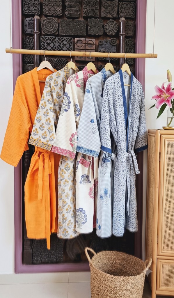Rose & Rang women's bathrobes — solid and floral designs hanging together